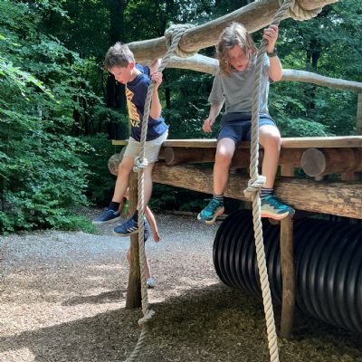 Two children climbing a rope